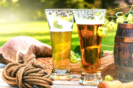 Glasses with fresh cold beer in rustic setting. Food and drink backgroundの写真素材