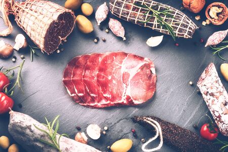 Gourmet dinner concept with sliced dry meat and various sausages. Food background with copyspaceの写真素材