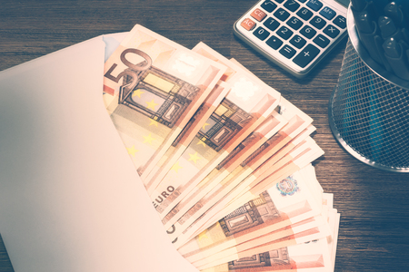 Pile of 50 euro banknotes in white envelope, closeup. Finances and budget conceptの写真素材