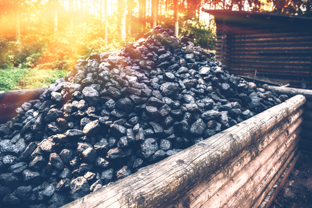 Coal mine wagon. Pile of charcoal in wooden trolley, closeupの写真素材