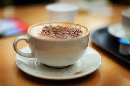 A still-life image of a cup of coffee, shot with a large aperture to create a narrow depth of field