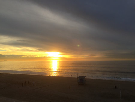 Sunrise Over the Calm Ocean, Painting the Sky With Colors Near the Shoreの写真素材