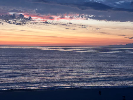 Vibrant Sunset Over the Calm Ocean, Painting the Sky With Hues of Pink, Orange, and Purple in Serene Evening Atmosphereの写真素材