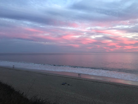 Stunning Sunset Views at the Beach With Gentle Waves and a Peaceful Atmosphere in the Evening Skyの写真素材