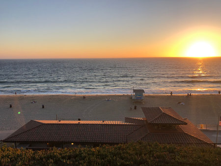 Beautiful Sunset Over the Ocean With a Peaceful Beach Scene and Gentle Waves in the Evening Lightの写真素材