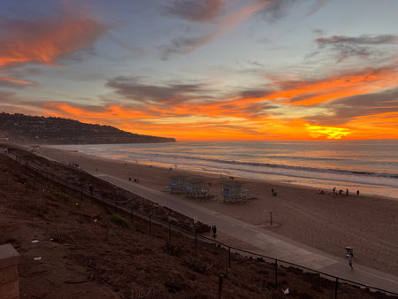 Beauty of Twilight on the Beach With Vibrant Sunset Hues Reflecting on the Waves Near the Coastlineの写真素材