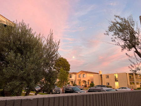 Evening Serenity Under a Pastel Sky With a Rising Moon and Quiet Suburban Streetsの写真素材