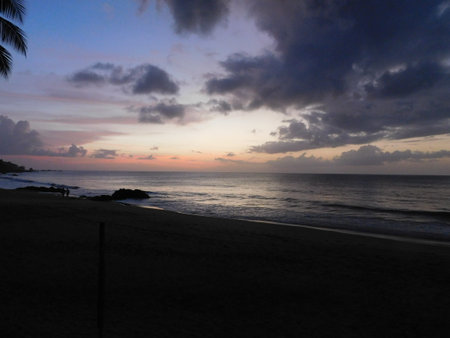 Serene Twilight Moment at a Tranquil Beach With Calm Ocean Waves and Colorful Skyの写真素材