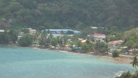 Tropical Village by the Shore Featuring Colorful Buildings and Lush Greenery by the Turquoise Seaの写真素材