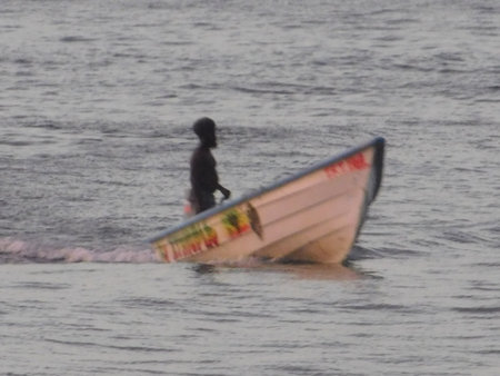 fisherman on the boat in the sea in the evening.の写真素材