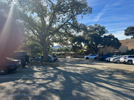 Sunny Afternoon at a Serene Parking Area Surrounded by Oak Trees, Inviting Visitors to Explore the Sceneryの写真素材