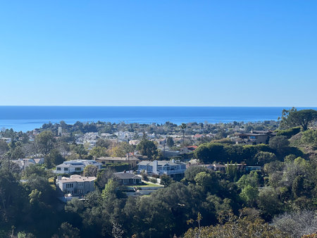 Scenic View Showcasing Coastal Homes and Lush Hills Under a Clear Blue Sky in California, Capturing Serene Beauty and Tranquilityの写真素材