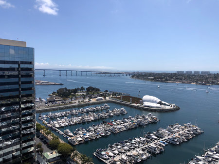 Stunning View of San Diego Bay Showcasing Boats and the Iconic Bridge Under a Bright Blue Skyの写真素材