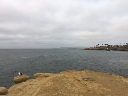 Coastal View at La Jolla With Gentle Waves and a Cloudy Sky During a Peaceful Afternoon Strollの写真素材