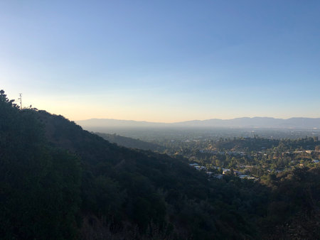 Breathtaking View of the Valley at Sunset Near the Hills, Capturing Nature's Beauty and Tranquilityの写真素材