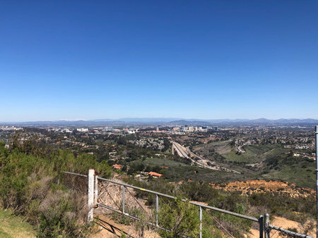 Scenic Viewpoint Showcases a Sprawling City Landscape Under a Clear Blue Sky in the Afternoonの写真素材