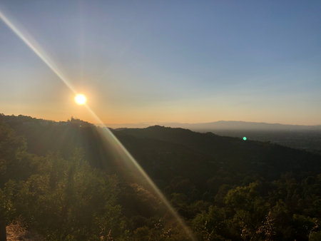 Golden Sunlight Bathes the Serene Hills at Sunset, Creating a Tranquil Atmosphere That Invites Reflection and Peaceの写真素材