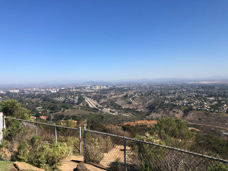 Scenic View of a Sprawling City Landscape Under a Clear Blue Sky From a Hillside Vantage Pointの写真素材