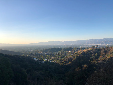 Bright Sunset Over the Hills and Valleys of Los Angeles Creates a Breathtaking View Filled With Vibrant Colors and Serene Landscapesの写真素材