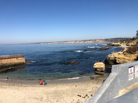 Coastal Bliss at La Jolla Shores With Clear Water, Soft Sand, and Happy Visitors Enjoying a Sunny Afternoonの写真素材