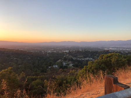 Breathtaking Sunset View Over a Valley With Mountains in the Distanceの写真素材