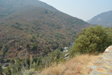 Gentle Hills Embrace a Winding River in the Tranquil Valley at Middayの写真素材