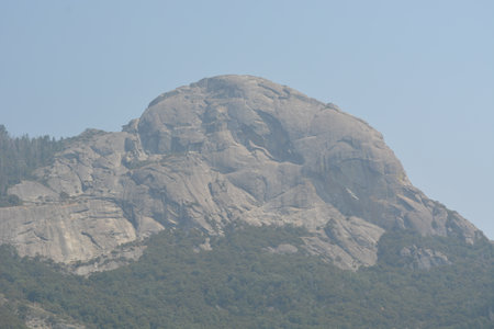 Granite Mountain Peak Rises Above Lush Greenery on a Hazy Summer Day in the Countrysideの写真素材