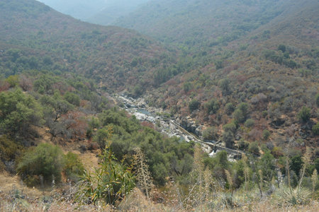 Scenic View of a Winding River Through the Mountains Under a Clear Sky in Late Summerの写真素材