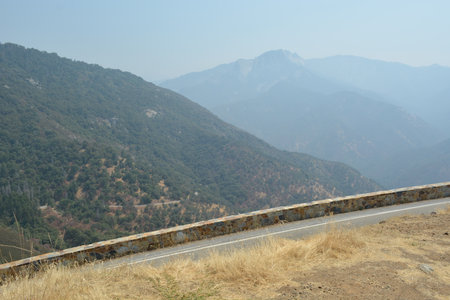 Scenic Mountain Landscape With Winding Road on a Sunny Day, Inviting Adventure in Nature's Beautyの写真素材