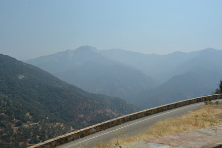Scenic Mountain View From a Winding Road Under a Hazy Sky in Early Afternoonの写真素材