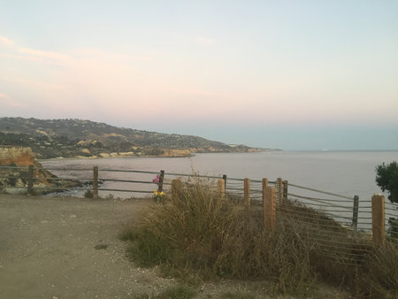 Quiet Evening by the Seaside, Golden Hues and Calm Waters Create a Serene Atmosphere at Sunsetの写真素材