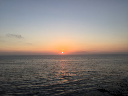 Vibrant Sunset Over Calm Ocean Waters Creates a Serene Evening Atmosphere for Peaceful Reflection and Inspirationの写真素材