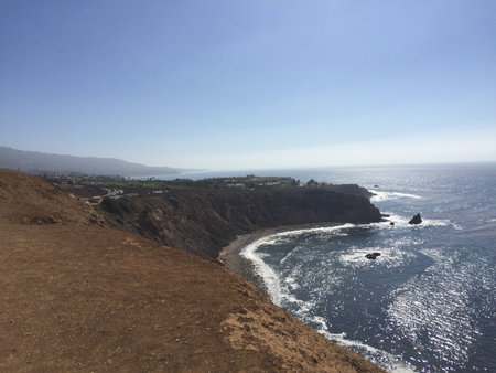 Stunning Coastal View at Golden Hour Showing Cliffs, Ocean, and Horizon Near a Picturesque Shoreline in Californiaの写真素材