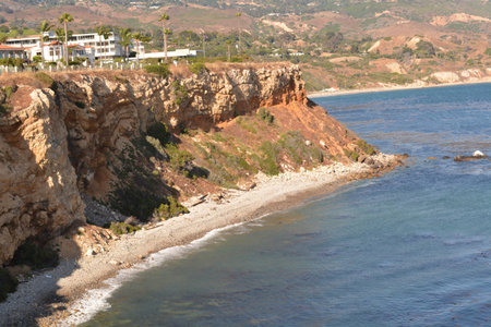 Majestic Coastal View With Rugged Cliffs and Gentle Waves Near a Serene Beach in Sunny Californiaの写真素材