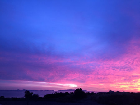 Breathtaking Twilight Sky Painting the Horizon With Vibrant Hues Above the Calm Sea at Duskの写真素材