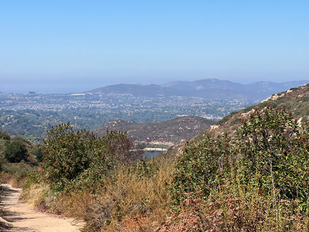 Scenic View of Rolling Hills and Distant Mountains on a Sunny Day Near San Diegoの写真素材