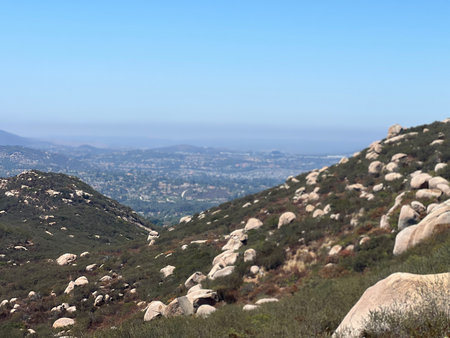 Scenic View of Rolling Hills and Boulders Under a Clear Blue Sky in the Countrysideの写真素材