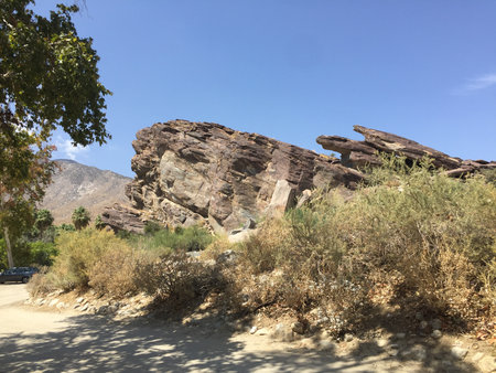 Stunning Rock Formation Under a Bright Blue Sky in a Serene Desert Landscape Near Palm Springsの写真素材