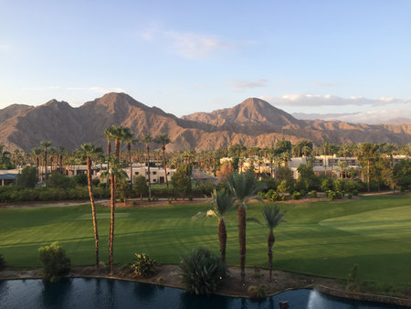 Desert Landscape at Sunset With Mountains and Lush Greenery in a Tranquil Settingの写真素材