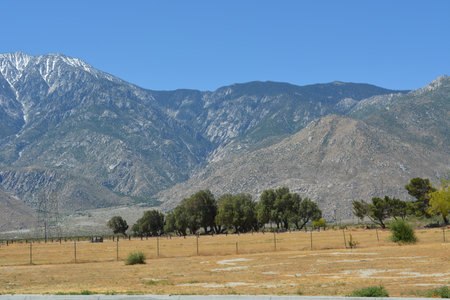 Majestic Mountains Rise Under Clear Blue Skies in a Tranquil Desert Landscapeの写真素材