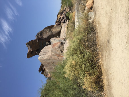 Majestic Rock Formations Under a Bright Blue Sky in a Serene Natural Settingの写真素材