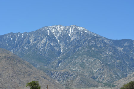 Majestic Mountain Peak Rises Under a Clear Blue Sky in a Serene Natural Landscapeの写真素材