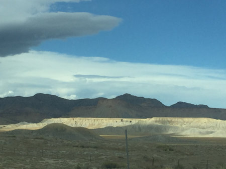 Scenic View of Dramatic Landscape Near Mountains Showcasing Unique Geological Features Under a Vibrant Skyの写真素材