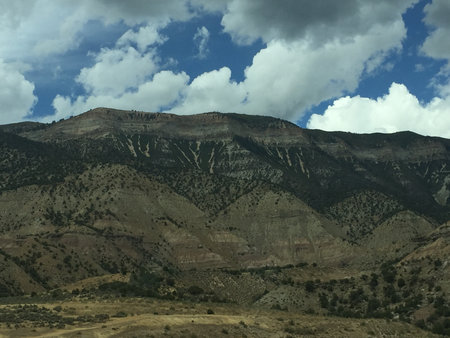 Majestic Mountain Landscape With Dramatic Clouds Creating a Serene Outdoor Scene in Early Afternoon Lightの写真素材