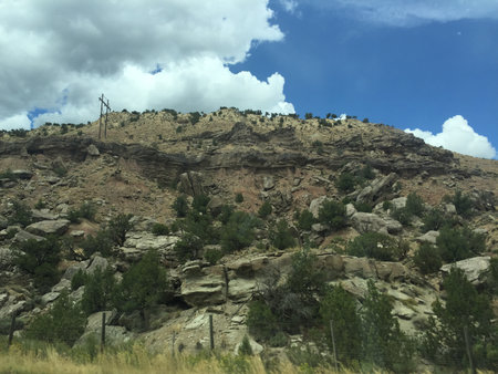Vibrant Landscape Showcasing Rocky Hills Under a Bright Blue Sky With Fluffy Clouds, Symbolizing Nature's Beauty and Tranquilityの写真素材
