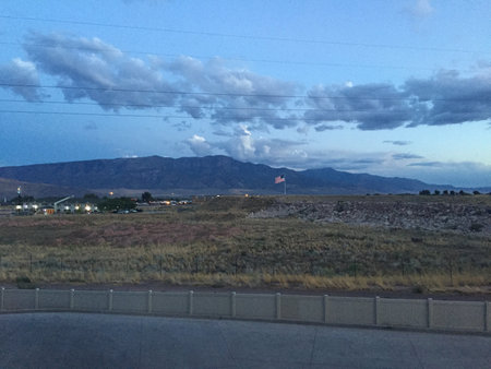 Majestic Mountains Under a Twilight Sky With a Gentle Breeze and a Flowing River in the Backgroundの写真素材