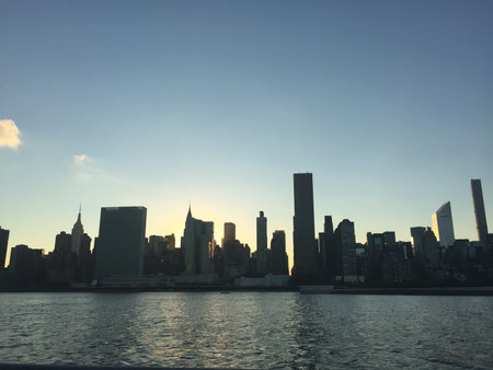 New York City Manhattan skyline at sunset with skyscrapers over Hudson River.の写真素材