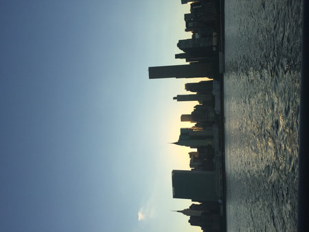 Sunset Over the Skyline With Shimmering Water Reflecting the Fading Lightの写真素材