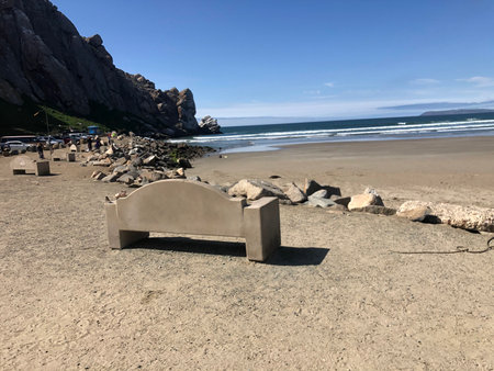 Coastal Serenity With a Rustic Bench Overlooking the Ocean at Morro Bay During a Sunny Afternoonの写真素材