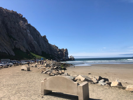 Scenic Beach View With Rocky Coastline and Clear Blue Skies on a Sunny Afternoonの写真素材